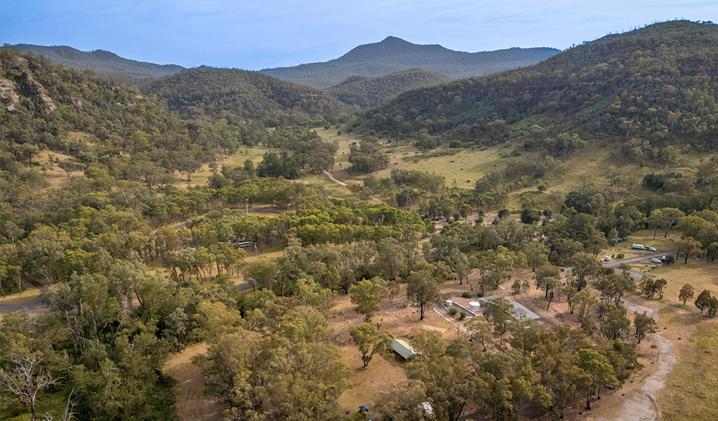 Aerial view of Camp Blackman with mountains in the background. Credit: John Spencer &copy; DCCEEW